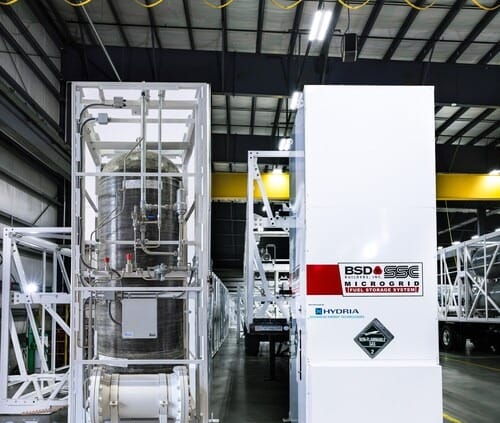 A high-pressure fuel storage system for a microgrid, showing an internal view of a carbon-fiber reinforced tank and an external view of the white protective enclosure with BSD Builders and SSC branding.